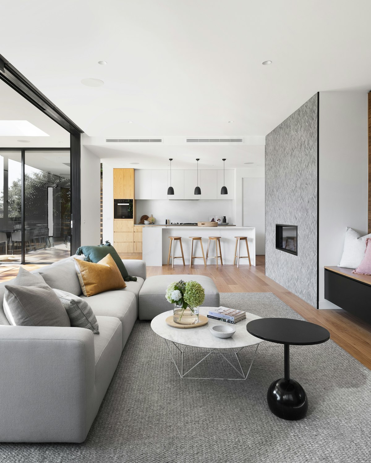 Bright and elegant luxury living room featuring clean line furniture and warm ambient lighting